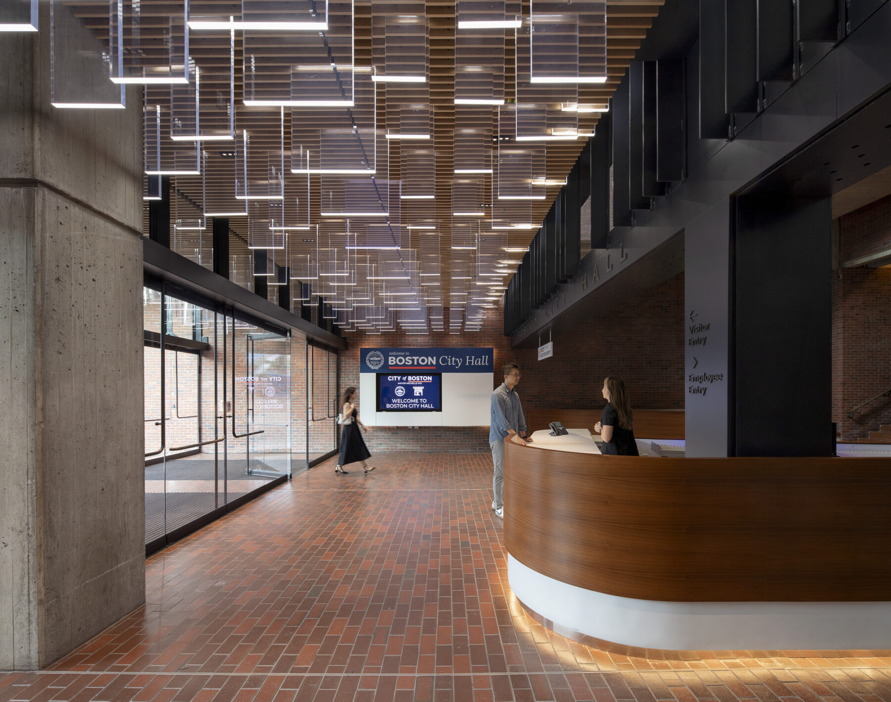 photograph of the interior of the north entrance to City Hall, featuring custom transparent light fixtures