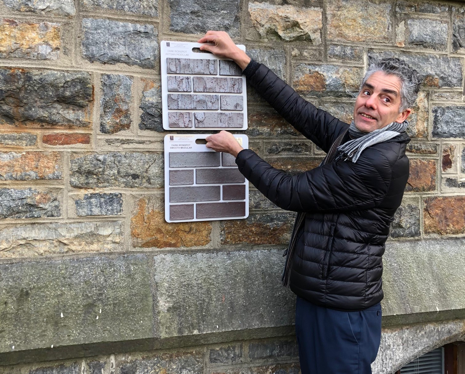 photo of Vinicius comparing brick samples